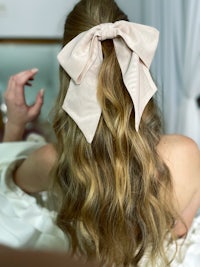 a woman with long hair and a bow in her hair